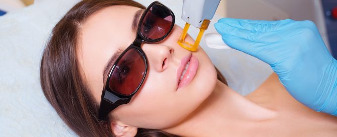 Young Woman Receiving Epilation Laser Treatment On Face At Beauty Center Close Up